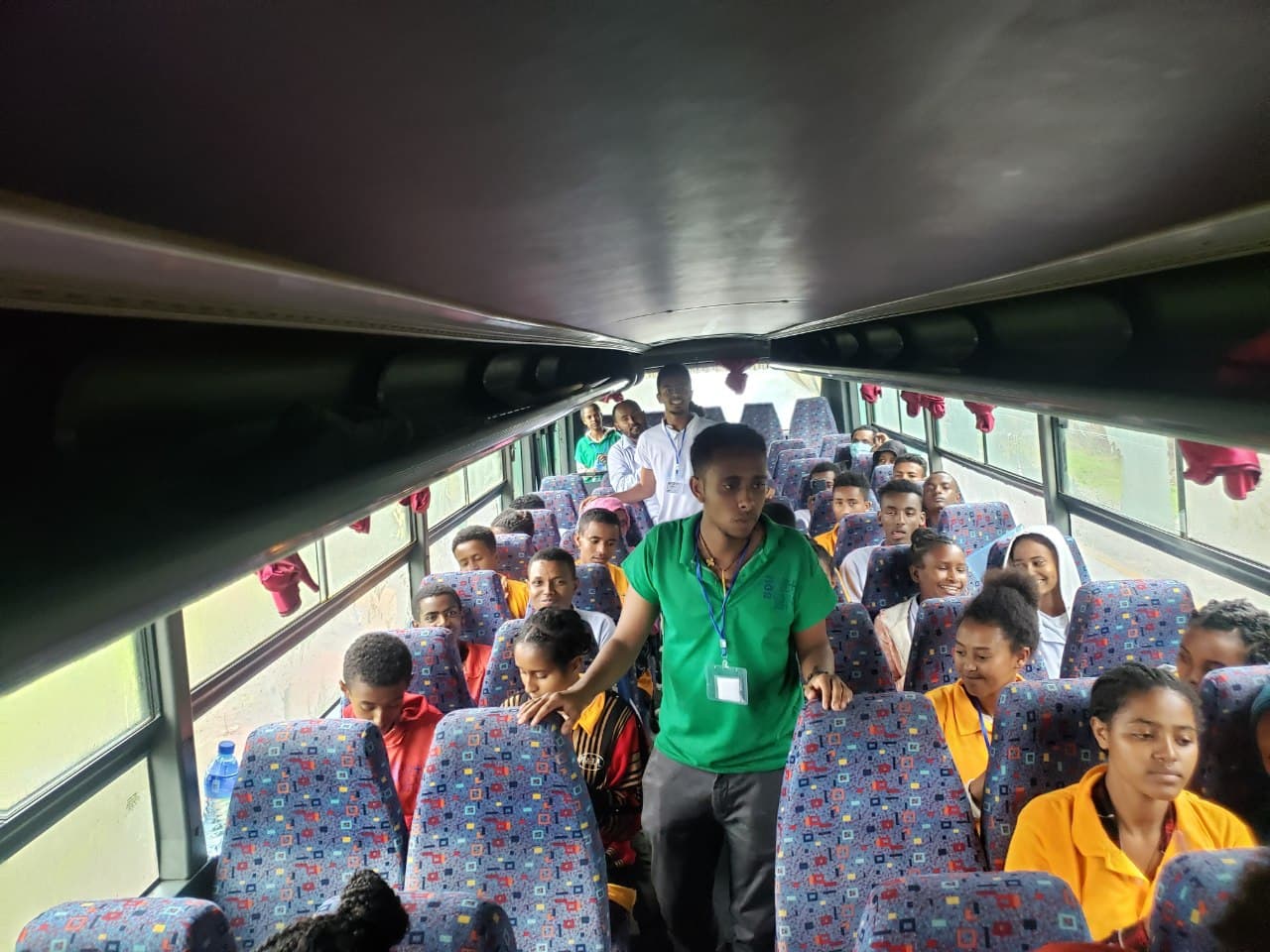 Biruk leading a chant in a bus ride